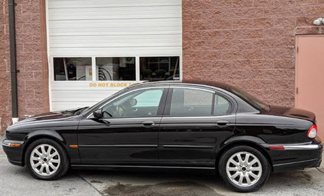 Black Jaguar X-Type Sedan Outside Our Garage